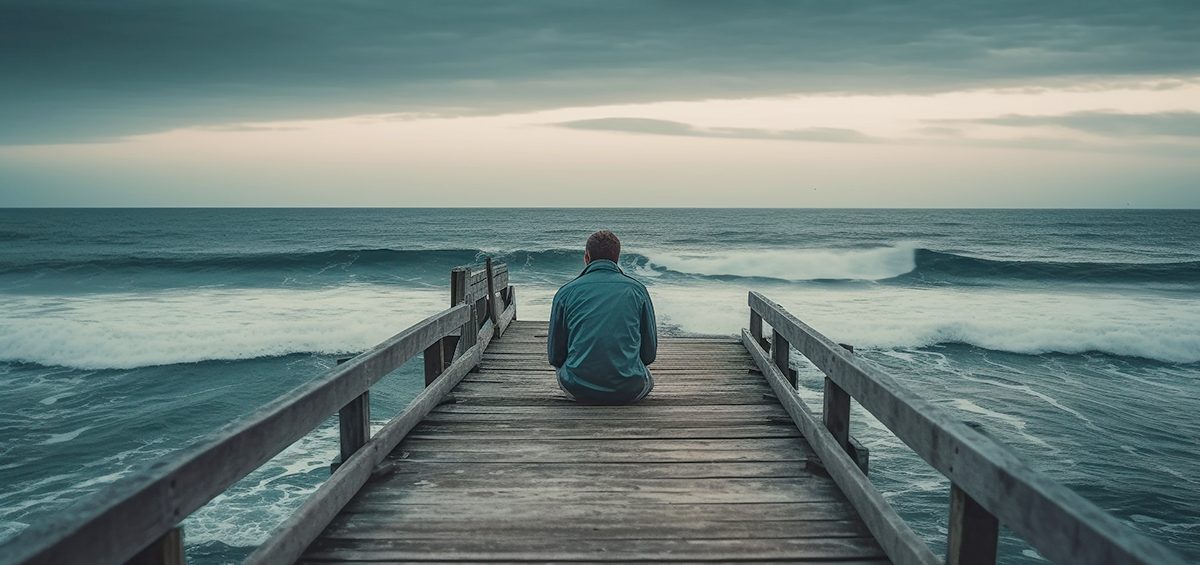 Man Grieving, Sitting On Dock
